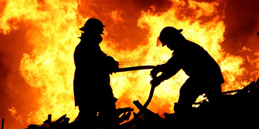 Two fire fighters and flames